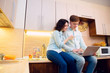 © zorgens - Couple with laptop in kitchen