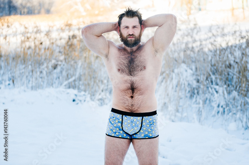 Portrait Of Russian Bearded Bodybuilder Man With Hairy Body Standing Without Clothes Outdoors In Winter On Snow In Cold Weather After Swimming And Posing For Camera Healthy Life Concept Buy This