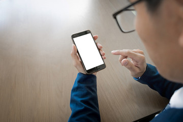 Wall Mural - Close up of a businessman using mobile smart phone on wooden table, business concept.