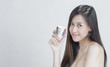 © jaengpeng - Skincare. Beauty Concept. Young pretty woman holding cosmetic cream
