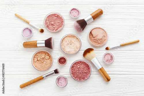 Fotografering Makeup powder products with brushes flat lay