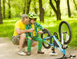 © Ermolaev Alexandr - Grandson with his grandfather pumped wheel bicycle