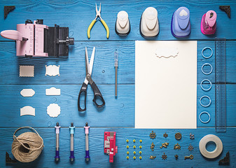 Wall Mural - top view of wooden table with tools for scrapbooking