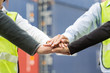 © Getty Gallery - Business team in logistic industry join hand for collaboration after project achieve with container cargo for export and import in background. Teamwork concept