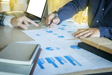 Wall Mural - Business teamwork process, Businessmen hands pointing at document during explanation of new plan project data at meeting.