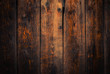 Old rural wooden wall in dark brown and orange colors, detailed plank photo texture. Natural wooden building structure background.