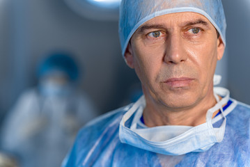 Sad male surgeon glancing despondently