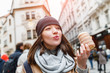 © EdNurg - Woman eats Trdelnik on the street market in Prague, Czech Republic