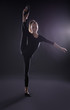 © Africa Studio - Young girl doing gymnastics on dark background