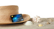 © Africa Studio - Sand with credit card and hat on white background