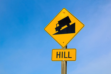 Approaching hill sign along highway