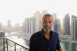 © phocal Media - Portrait of Expat man at balcony.