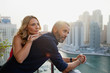 © phocal Media - Couple leaning at balcony.