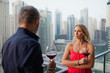 © phocal Media - Couple drinking wine at balcony.