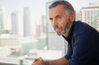 © phocal Media - Expat man looking outdoors.