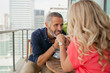 © phocal Media - Couple holding hands at balcony.