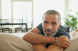 © phocal Media - Portrait of man leaning on couch.