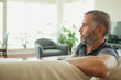 © phocal Media - Man relaxing at home.