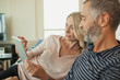 © phocal Media - Couple using digital tablet at home.