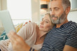 © phocal Media - Couple using digital tablet.