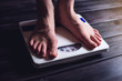 © Artem - Women's feet are on mechanical scales for weight control