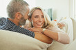© phocal Media - Couple relaxing on couch.