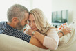 © phocal Media - Couple relaxing on couch.