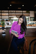 © phocal Media - Woman using digital tablet at restaurant.