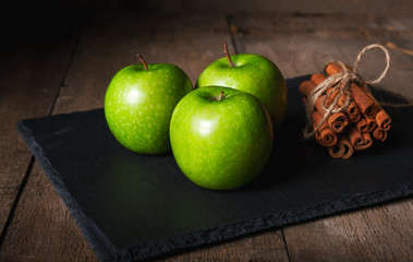 Wall Mural - Cinnamon sticks,apples on wooden table background