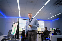 Portrait Of Operator In Automotive Emergency Response Control Room In Car Factory