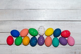 Fototapeta  - Easter eggs hand painted on wooden background. Happy Easter