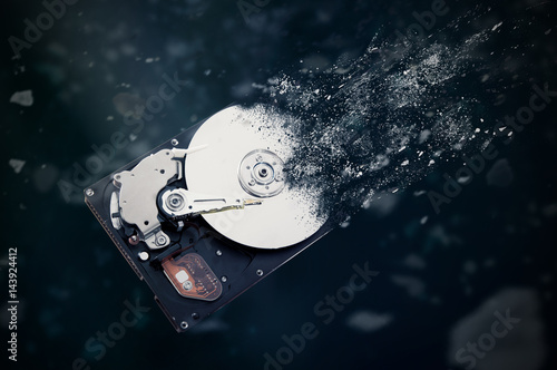 Fotomural The old hard disk drive is disintegrating in space