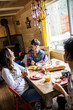© Connect Images - Three friends sitting around table, eating breakfast