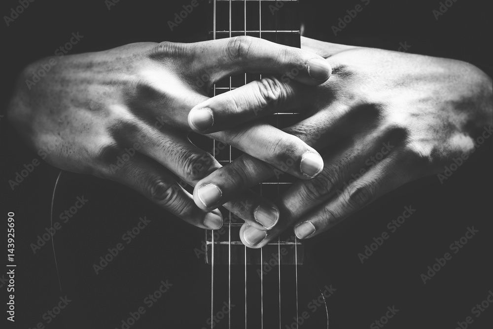 musician hands on guitar neck. black and white, music background - obrazy, fototapety, plakaty 
