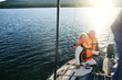 © pressmaster - Happy tourists in life-vests enjoying yacht travel