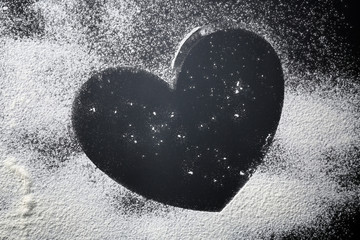 Canvas Print - Heart made of flour on dark background, closeup