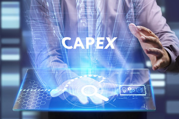 Business, Technology, Internet and network concept. Young businessman working on a virtual screen of the future and sees the inscription: Capex