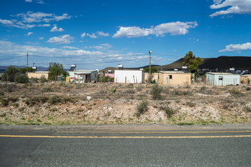 township with mountain backdrop and highway, western cape, south africa