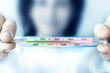 © Евгений Вдовин - The girl holds a medical thermometer in her hands, showing the temperature of the sick person