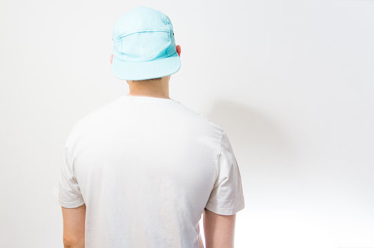 Fototapete - the man, guy in the blank white, Turquoise  baseball cap,  on a white background, mock up, free space, logo presentation , template for print,  design,