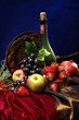 Dutch still life on a velvet tablecloth of juicy fruits and a dusty old bottle of wine, vertical