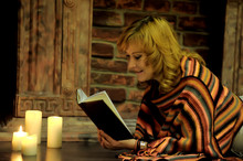Middle-aged Woman With Candles And Book