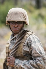 Wall Mural - Military soldier standing with ammunition