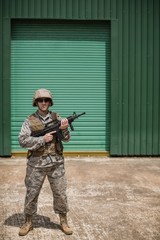 Military soldier standing with a rifle