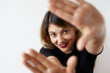 © shurkin_son - Close up portrait of pretty student female with cute smile looking at camera with happy joyful expression and gesturing hands frame on white background. Selective focus on face. Having fun concept