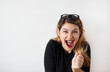 © shurkin_son - Portrait of shocked young woman in casual black dress and glasses, happy super offer at her favorite store, staring at camera with shocked look, feeling wonderment and shock, screaming 'Omg'