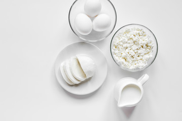 monochrome concept with dairy products on white table top view mockup