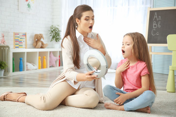 Young woman teacher and little girl on private lesson