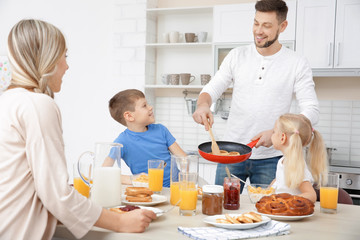 Canvas Print - Happy family having breakfast on kitchen