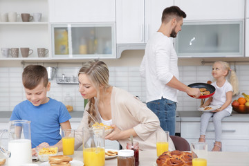 Poster - Happy family having breakfast on kitchen